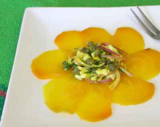 Thin slices of golden beet, topped with a bit of caper & egg salad