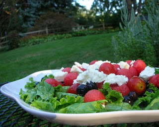 Summer fruit in a gorgeous dressing, atop greens