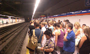 . their valuable strike time to bring you their personal train. (madrid metro crowded platform)