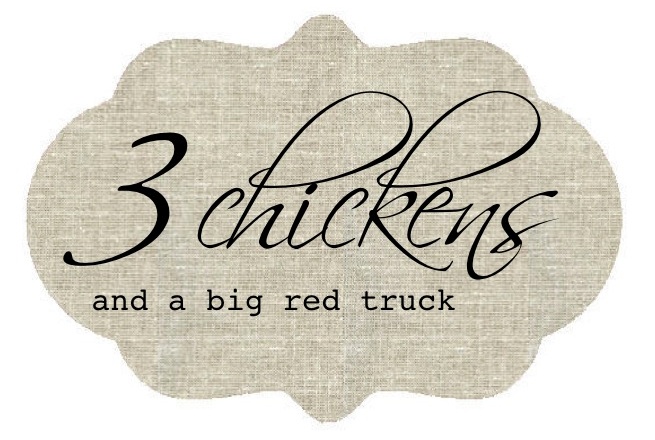 three chickens and a big red truck