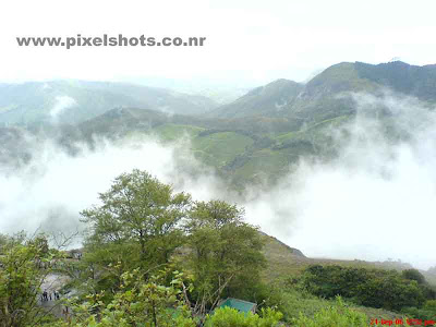 photograph of mist in munnar hillstation kerala,mist moving over mountains in munnar