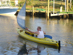 Dad in kayak with sail