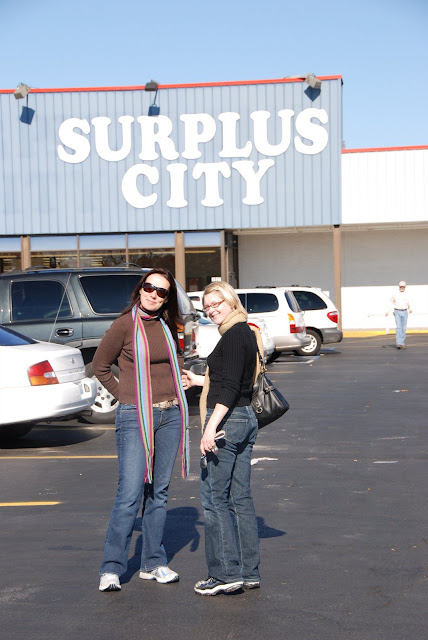two women standing in front of surplus city