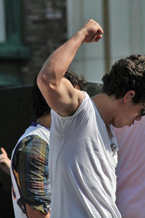 Not only is Nick Jonas showing off his lovely man muscles but he's also not 