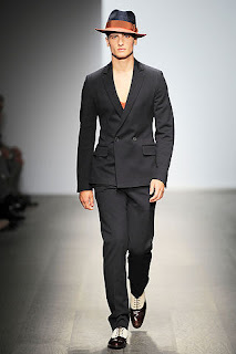 man in black suit and hat on runway