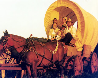 family in covered wagon