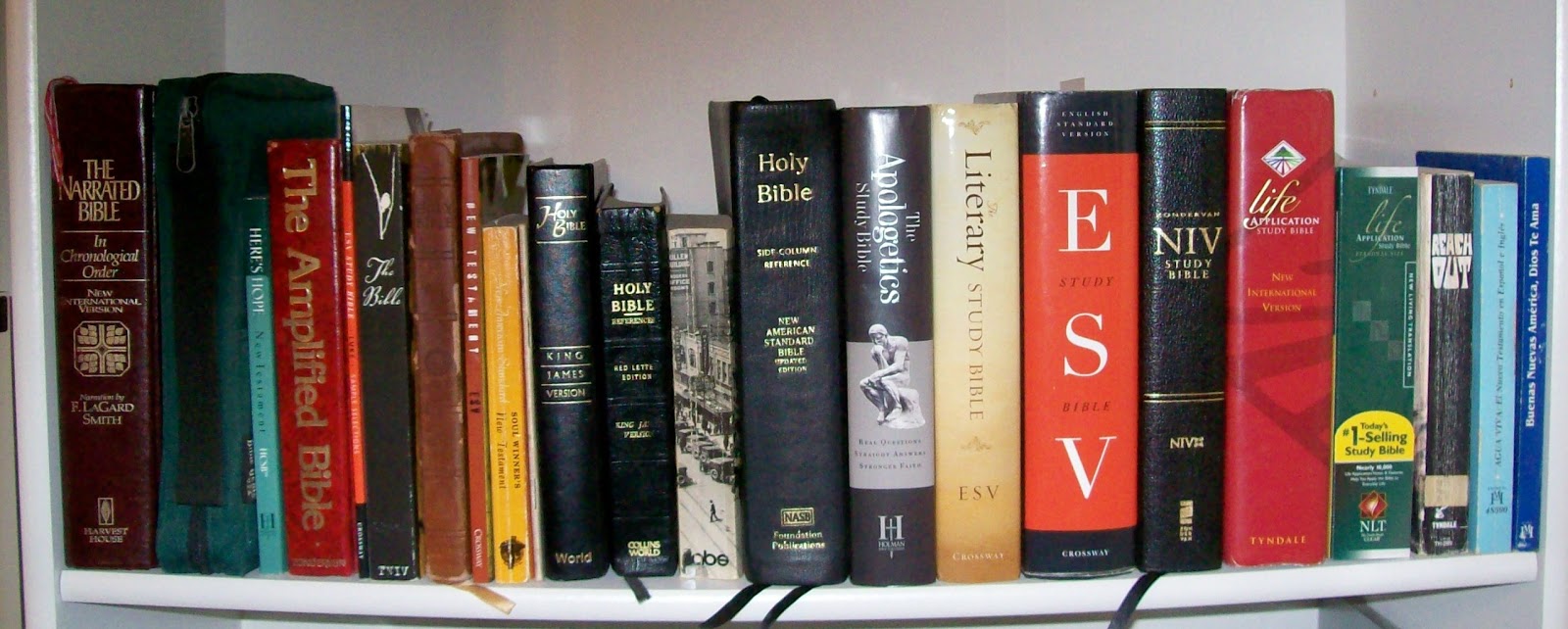 Bookshelf with many Bibles on it