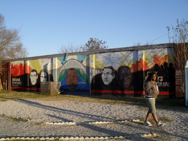 Young woman walks past civil rights mural in Selma, Ala., March 2010