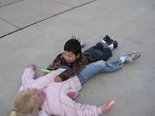 Caleb pins Abby in the driveway while playing sidewalk chalk
