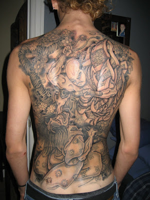 Traditional Japanese tattoo covers arms shoulders and the back