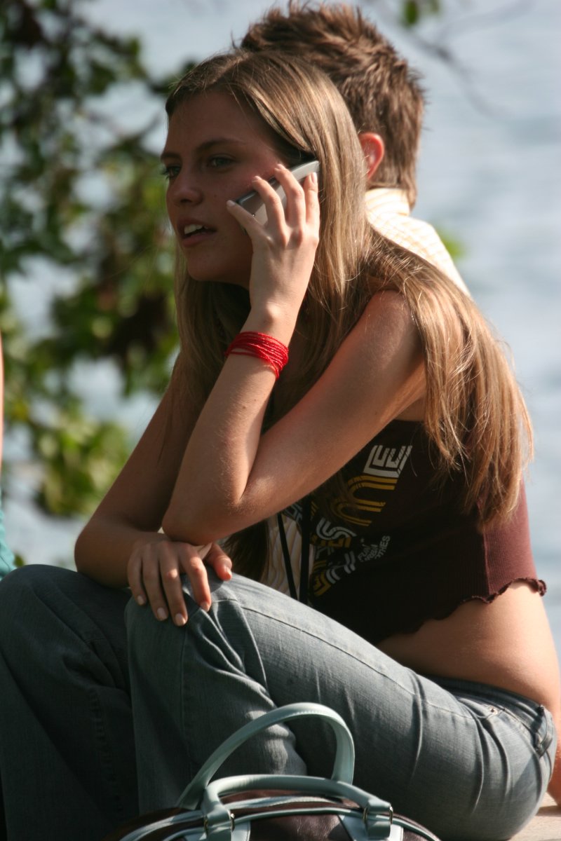 [Young_woman_using_a_mobile_phone.jpg]