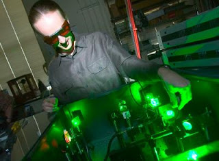 Caption: Matthew Pelton of Argonne's Center for Nanoscale Materials adjusts a green laser used to monitor the sporadic blinking of quantum dots. Credit: Jason Smith. Usage Restrictions: None.
