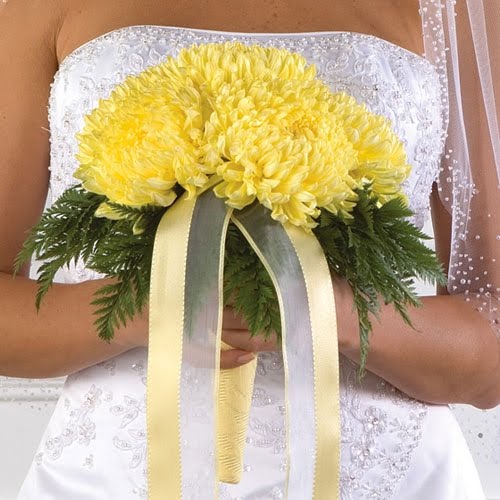 Romantic yellow wedding bouquet made up of yellow chrysanthemums with yellow