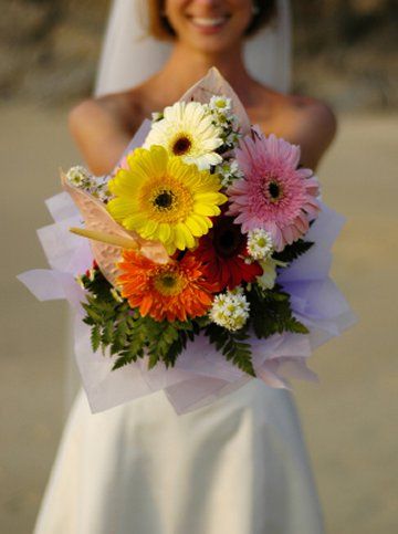 Yellow hot pink and fuchsia gerbera daisies mixed with orange lilies 