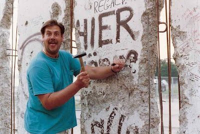 Drew posing with hammer and chisel at the Berlin Wall in 1990 Drew posing with hammer and chisel at the Berlin Wall in 1990