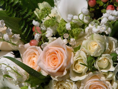 The apricot cream wedding bouquet was designed in a traditional cascading 