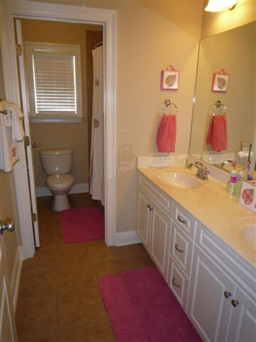 Jack n Jill Bath with two sinks and door to toilet and bathtub room