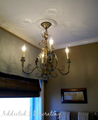 Master bathroom makeover--chandelier over tub, natural woven roman shade, valance