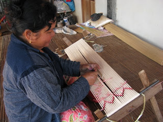 Thai weaver wrapping mudmee pattern for indigo dyeing