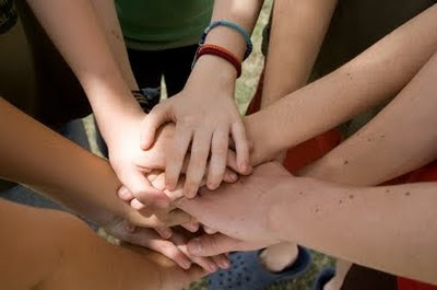 NAMC montessori grace and courtesy in lower elementary classrooms stacking hands