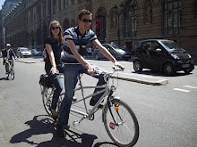A couple cycling on the main road outside the "Louvre Museum".(Sunday 23-5-2010).