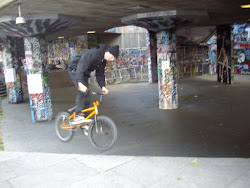 "BMX Biker" demonstrating his skills in a garage basement.
