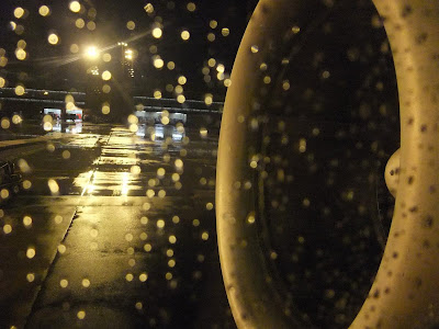 sitting in a plane, in the rain, on the window