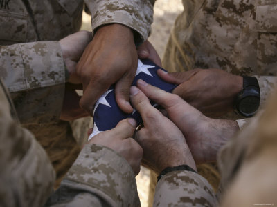 [stk102498m~Marines-Fold-an-American-Flag-after-It-was-Raised-in-Memory-of-a-Fallen-Soldier-Posters.jpg]