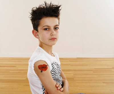 Tattoo of red heart on a young boy's sleeve at 614 PM