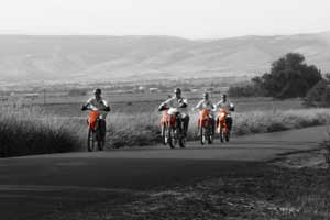 Backyard Country Wedding Ellensburg Wedding Photo o f groomsmen riding on ktm dirtbikes