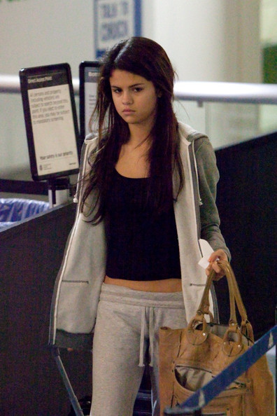 Selena Gomez is not in the mood for the paparazzi as she heads out to LAX