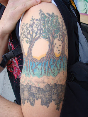 I initially just saw the bottom of this tattoo an inverted cityscape poking
