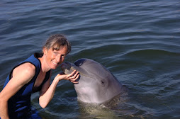 Debbie getting a dolphin kiss from Pax.