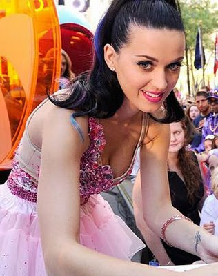 Katy Perry* shows off a look which includes nail gems and a contrasting