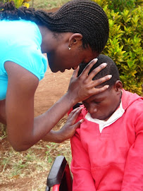 Prayer with one of the children at the outreach..Summer 2008