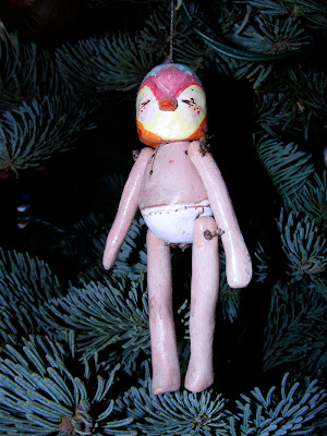 trimming the tree, bird head human body figurine