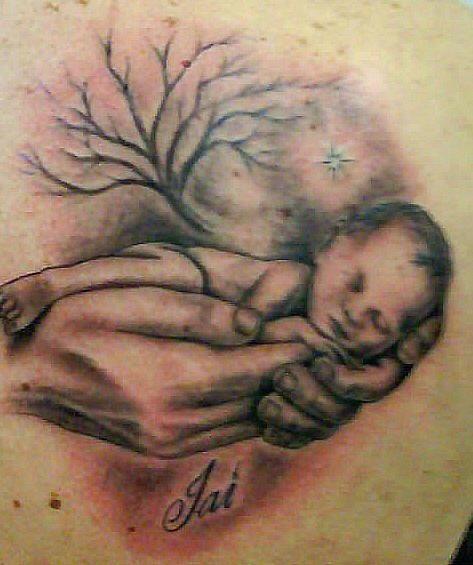 Small baby sleeping in hands tattoo