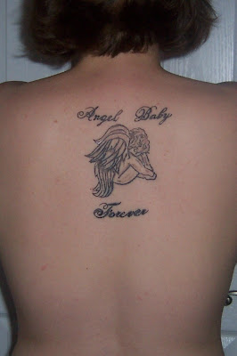 Praying baby angel tattoo.