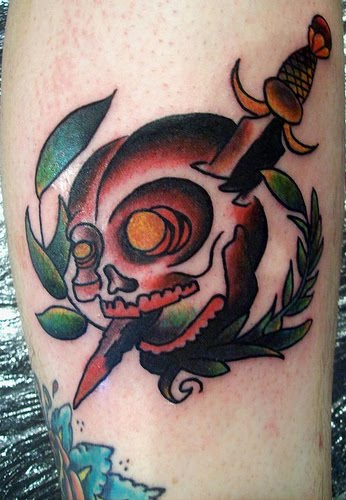 Skull and dagger with wreath tattoo.