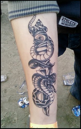 Snake and dagger with eye tattoo.