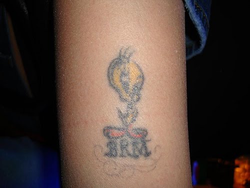 Tweety Bird and initials tattoo.