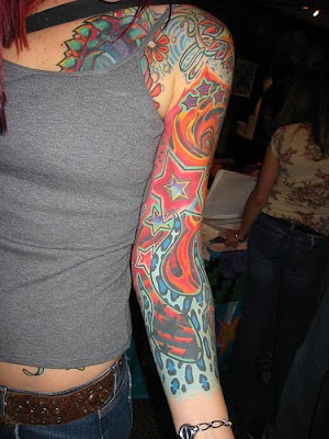 Stars and flames arm tattoo