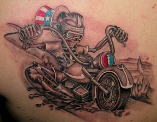 Man lying on motorcycle tattoo. Harley Davidson tattoos are perhaps the most 
