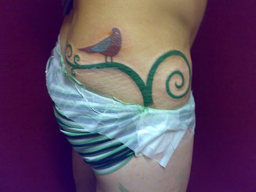 perched bird tattoo