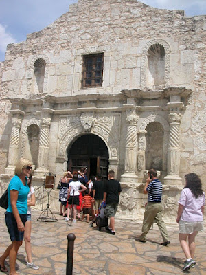 Caitlin, JD, Andrew, Bryan pushing Mikey, and Carrie at the entrance to the Alamo