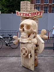  statue with skull and crossbones over bank vault