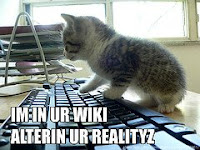 Cat on a computer picture; caption says I'm in your wiki, altering your reality