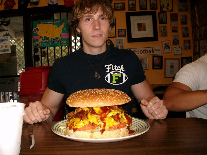 Josh in front of a big Cheeseburger