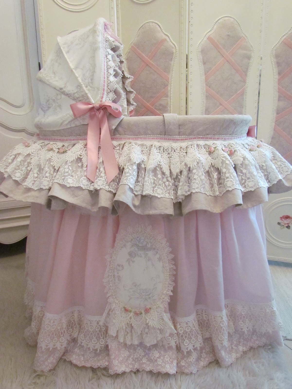 Angela Lace A very pink Moses basket.