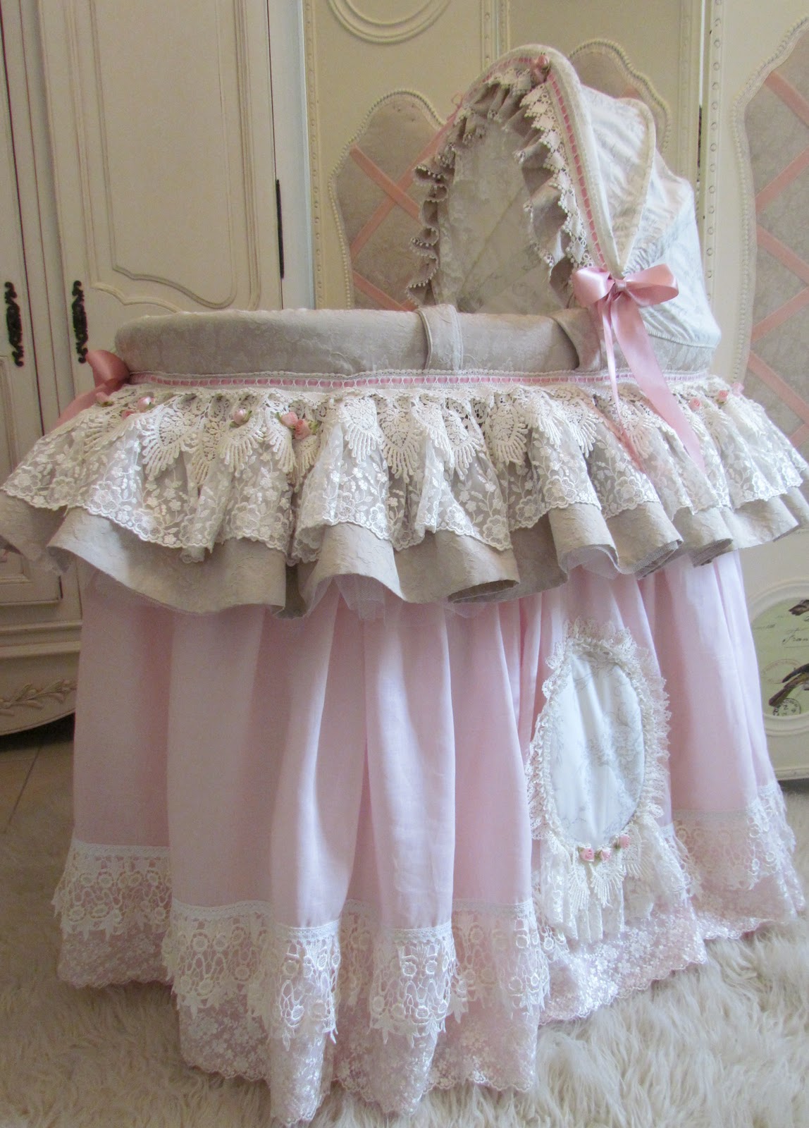 Angela Lace A very pink Moses basket.